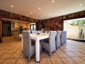 a dining room with a white table and chairs at 29 on Edward - 4 bedroom House in Cape Town