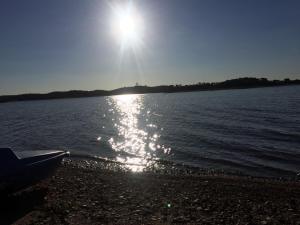 a boat on the shore of a body of water at Hostal Rural La Casa Verde in Cheles