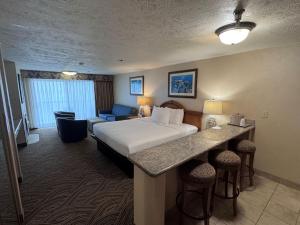 a hotel room with a bed and a couch at Promenade Inn & Suites Oceanfront in Seaside