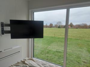 a view of a field from a bedroom window at Natuurhuisje 't Hoogbos - Bosrand in Schijf