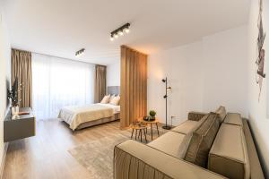 a living room with a couch and a bed at SB Nest Studio in Braşov +15 photos