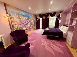 a living room with a bed and a couch at Apartments Provence in Chernivtsi