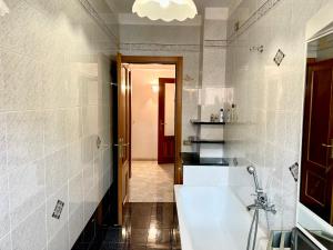 a bathroom with a white tub and a sink at La Casa di Luci in Rosia +57 photos