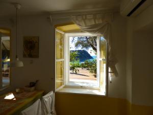 a window in a room with a view of the ocean at Apartments Olive Garden in Piran