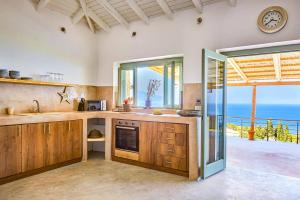 a kitchen with a view of the ocean at Villa Thea by Villa Plus in Skinária