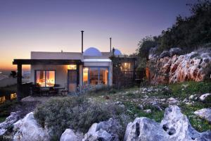 a house on the side of a mountain at night at דארנא בגליל in Lavon
