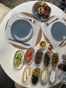 a white table topped with plates and bowls of food at Goji's Apartments in Istanbul
