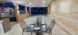 a table and chairs on a patio at Victoria's Apartments in Néa Tríglia