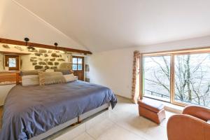 a bedroom with a bed and a large window at Peponi Classé 4 étoiles - Piscine - Parc des Monts d'Ardèche in Gourdon +29 photos