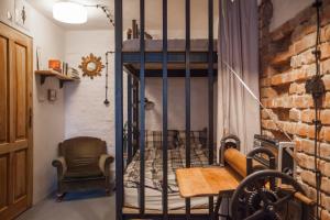 a room with a bunk bed and a table and chair at Apartment by the cathedral II in Lublin +17 photos