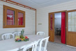 a table with a bowl of fruit on it in a room at Camping Village Tuscia Tirrenica in Tarquinia