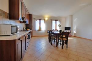 uma cozinha com uma mesa e algumas cadeiras e uma cozinha com uma mesa; em Il giardino di Marina em Teulada mais 20 fotografias