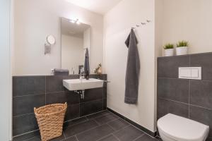 a bathroom with a sink and a toilet at Rodehuus Wohnung 7 in Borkum