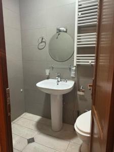 a bathroom with a sink and a mirror and a toilet at Local Hotel in Tbilisi City +52 photos