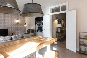 a living room with a table and a couch at Charming Design House In Montijo With Garden - 43 in Montijo
