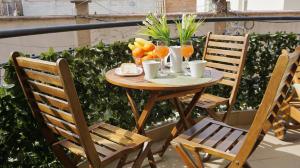 a wooden table with oranges and drinks on a balcony at Апартамент Деа - Apartment Dea in Byala