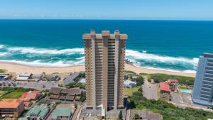 an aerial view of a building and the beach at Sea facing apartment 1703 on High Tide Amanzimtoti in Amanzimtoti