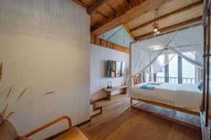 Postel nebo postele na pokoji v ubytování Yichun Jiuyu Xinzhi Light Luxury B&B