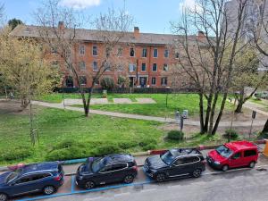a row of cars parked in a parking lot in front of a building at Lucazione Turistica in Mestre