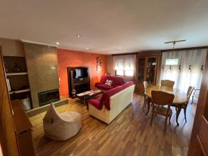 a living room with a couch and a table at Casa La Parra en Teruel in Villastar