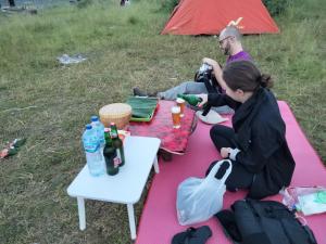 a man and a woman sitting on a picnic blanket at 3 days jungle trekking adventure tour and camping in Munduk