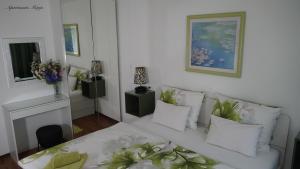 a living room with a white couch and a fireplace at Apartments Marja in Njivice
