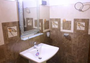a bathroom with a sink and a mirror at Wilpattu lake resort in Horuwila