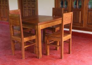 a wooden table with two chairs and a wooden table and chairsktop at Wilpattu lake resort in Horuwila +8 photos
