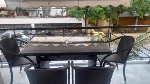 a table with two chairs and a table with a cake on it at holidays Nea Peramo in Nea Peramos
