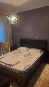 a bedroom with a large bed with at holidays Nea Peramo in Nea Peramos