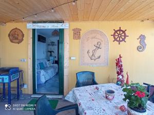 a room with a table and a room with a bedroom at Casa Ancora in Massa Lubrense +9 photos