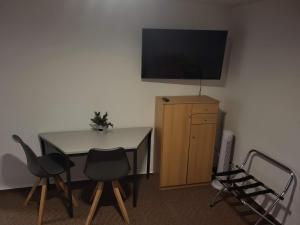 a room with a table and a television on a wall at Monteur-, Ferien- und Gästehaus in Groß Rossau in Osterburg