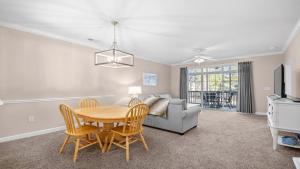 a living room with a table and a couch at 422 Cypress Bend Condo in North Myrtle Beach