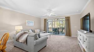 a living room with a couch and a tv at 422 Cypress Bend Condo in North Myrtle Beach +17 photos