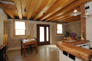 a kitchen with a table and a wooden ceiling at Casa Tormena in Valdobbiadene +53 photos