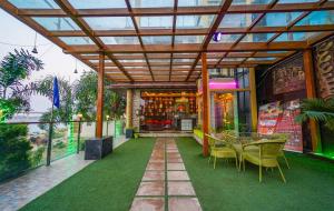 a patio with a table and chairs and a building at Shiv Rudraksh Resort, Near Assi Ghat in Varanasi