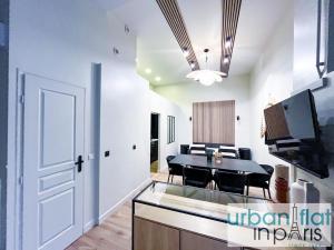 a living room and dining room with a dining table at 05 - Parisian Design Loft in Paris