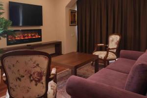 a living room with a couch and a fireplace at Phellos Suites Boutique Hotel in Şile