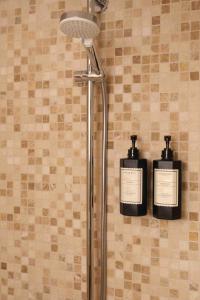 a bathroom with two bottles ofodorizers on a wall at Phellos Suites Boutique Hotel in Şile