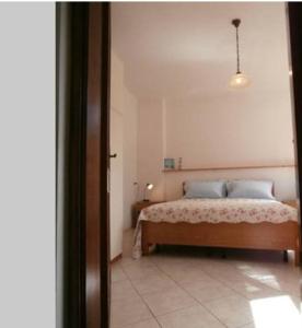 a bedroom with a bed with blue pillows at Marianna Home and Parking in Monterosso al Mare