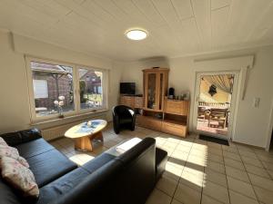 a living room with a couch and a table at Bliede RE05 in Sögel
