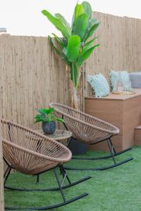 two rattan chairs and a table in a room at Paradise Heated Jacuzzi with Acropolis View in Athens