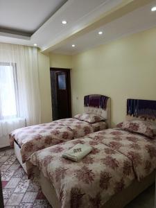 a hotel room with two beds and a window at AYDIN HOME Uzungöl in Uzungöl
