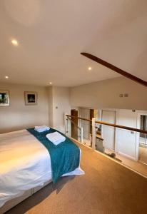 a bedroom with a large bed in a room at Minafon in Llanbedr