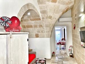 a room with a stone wall and a red heart on the wall at Antica Pietra in Polignano a Mare