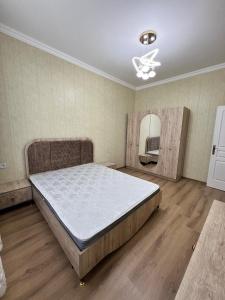 a bedroom with a large bed and a mirror at Sumqayıt Bulvar in Sumqayyt