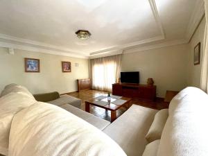 a living room with a couch and a table at Home Campoamor in Orihuela Costa