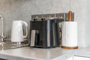 a kitchen counter with a coffee pot and a roll of paper towels at 2 Bedroom flat for Corporate, workers, Relocation, West st in Buckinghamshire