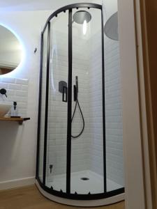 a shower with a glass door in a bathroom at Castle apartment Aga in Uzzano +27 photos