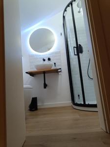 a bathroom with a sink and a mirror at Castle apartment Aga in Uzzano